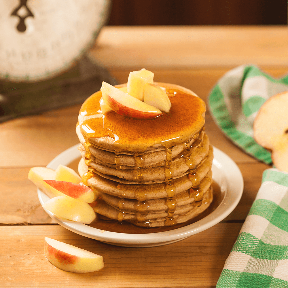 Stack of pancakes with apple slices