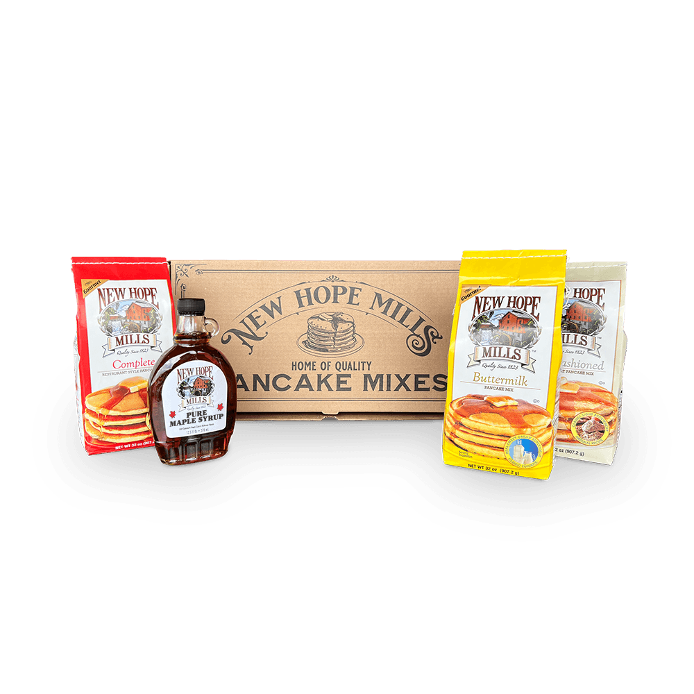 Photo of the Seneca Gift box, which includes a 2lb Buttermilk, a 2lb Complete, and a 2lb Old Fashioned Pancake mixes, with a 12.5 fl oz glass bottle of Pure Maple Syrup