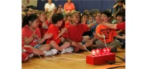 The Unique Game Show uses multi-media trivia and team-building activities to combine team spirit, character education, and curriculum enforcement into one program.