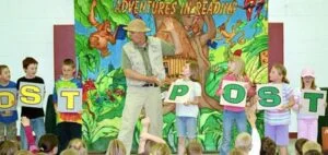 The Adventures in Reading School Assembly helps students explore books and discovery that reading leads to many rewards.