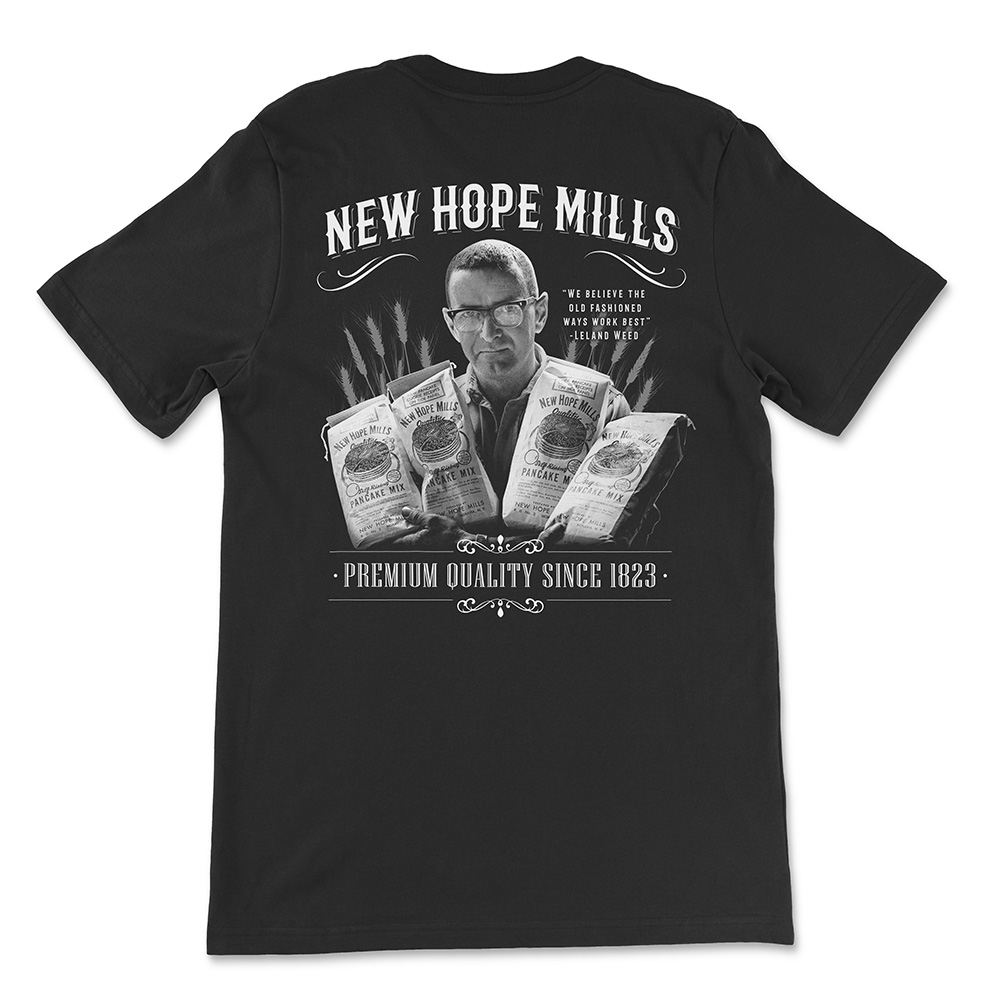 T-Shirt Back; black with white "楚尘宋颜小说免费阅读无弹窗" and "Premium Quality Since 1823" text with an image of Leland Weed holding bags pancake mix