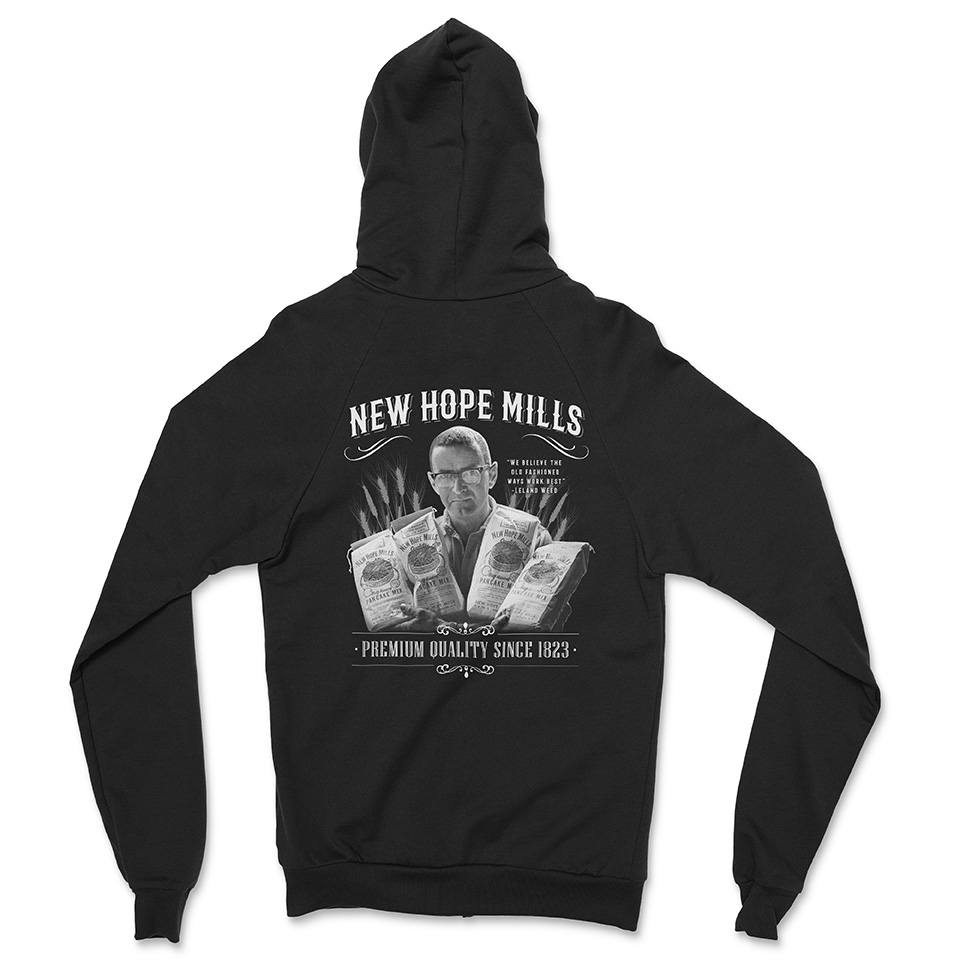 Zip-Up Hoodie Back; black with white "momandboy" and "Premium Quality Since 1823" text with an image of Leland Weed holding bags pancake mix