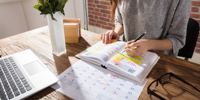 woman writing in planner
