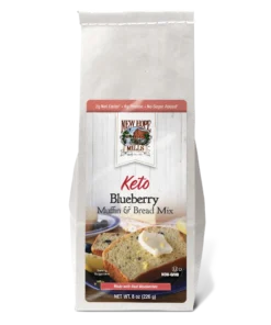 Front of the Keto Blueberry Muffin & Bread Mix, showing delicious looking bread with butter and blueberries on a plate.