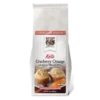Front of the Keto Cranberry Orange Muffin & Bread Mix, showing delicious looking muffins with cranberries and an orange piece on a plate.